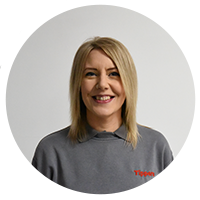 Kate young female with shoulder length blonde hair smiling, wearing grey jumper with red Tippers logo.