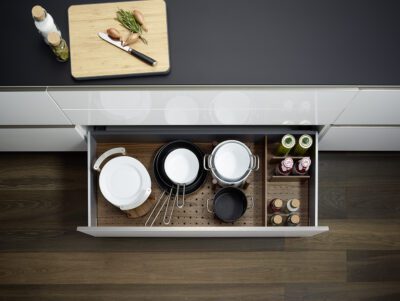 deep drawer with wood inserts and wooden pegs to divide space in drawer